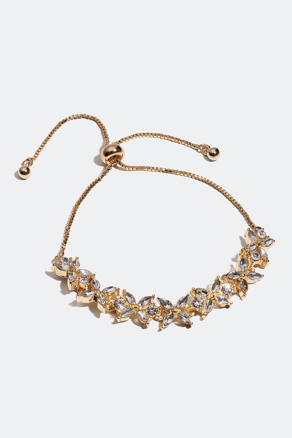 Guldfärgat armband med blommotiv och glasstenar i gruppen Smycken / Armband hos Glitter (251001010202)